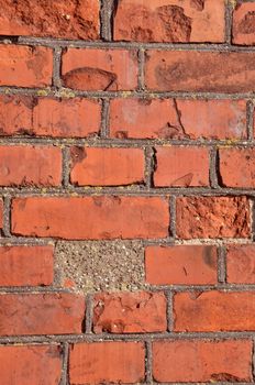 Fragment of old squared red brick wall.