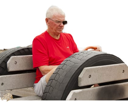 Grandfather sitting in playground car