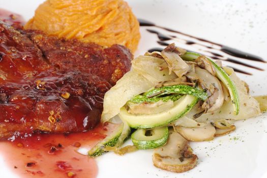 Rib with red sauce, vegetables and sweet potato puree (Selective Focus, Focus on front of the meat and the vegetable pile)