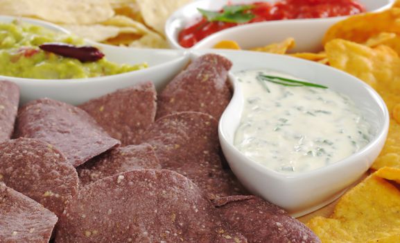 Peruvian purple corn chips with cream cheese dip among other chips and dips (Selective Focus, Focus on the front)