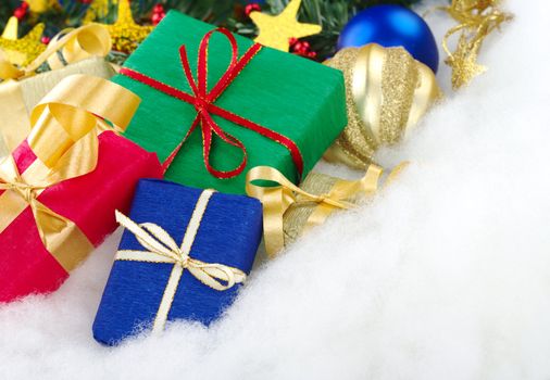 Colorful Christmas presents with Christmas decoration on cotton (Selective Focus, Focus on the blue box)