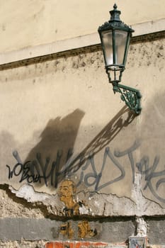 An antique lamp-post above urban decay in the back streets of Prague.
