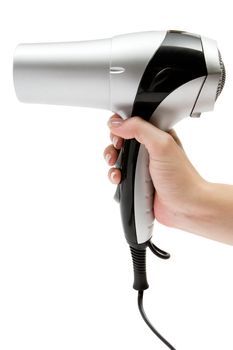 Female hand holding a silver hair drier. Isolated on a white background.
