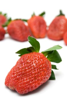 Bunch of Strawberries. Front one focused. Isolated on a white background.