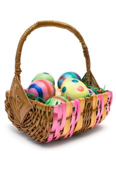 Woven basket full of colorful eggs. Isolated on a white background.