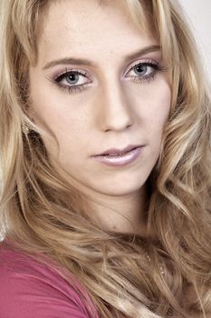 Studio portrait of a long blond girl looking hurt