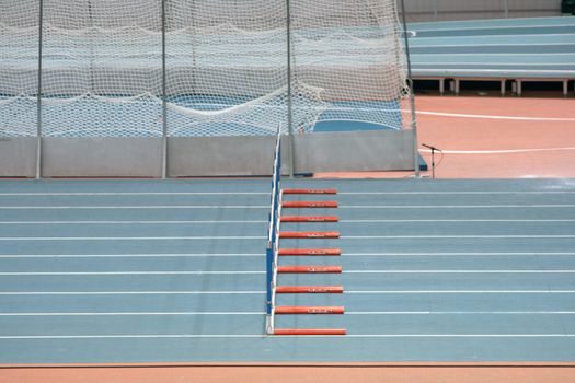 indoor hurdlers race track sport and athletics concepts