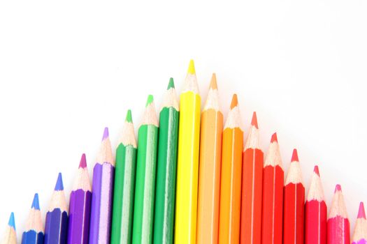 colorful arrow made of pencils isolated on white background