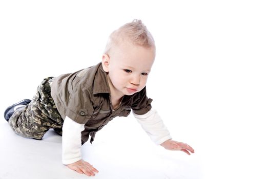 Studio portrait of a crawling baby boy