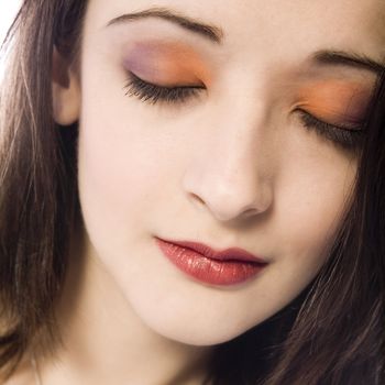 Studio portrait of pretty brunette with colourfull make-up