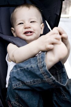 Studio portrait of baby boy playing with his toes