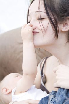 Studio portrait of pretty brunette and her baby son