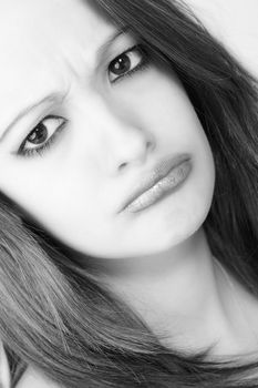 Studio portrait of pretty brunette looking angry