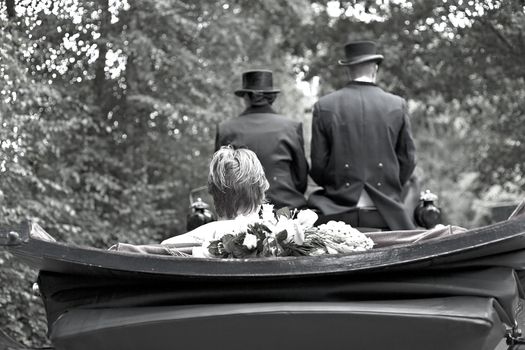 Groom sitting in a coach on his way to his bride