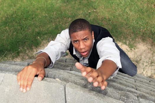 Man reaching for help while climbing a wall