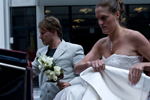 Bride and groom arriving by coach for their wedding