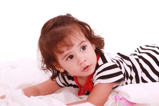 baby girl lying on the bed with swimsuit with space for advertising