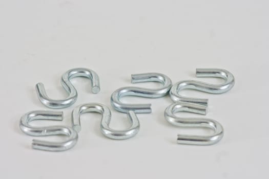 Six "s" hooks on a white background.