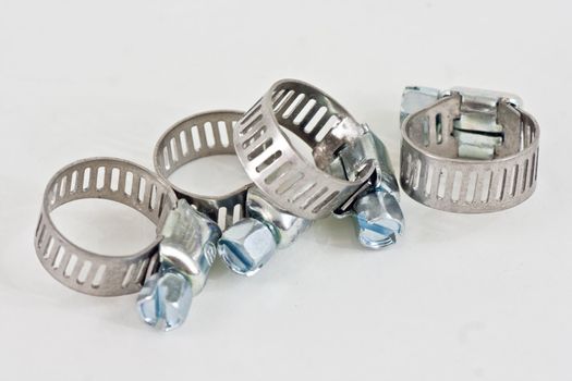 Five hose clamps on a white background.