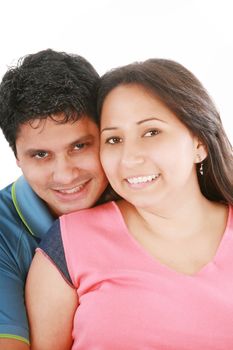 Portrait of handsome man hugging his wife from behind against white background