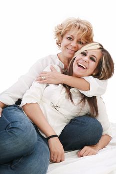 Mother and daughter sitting and laughing on the floor