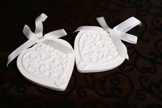 White Ceramic hearts with white ribbons tied