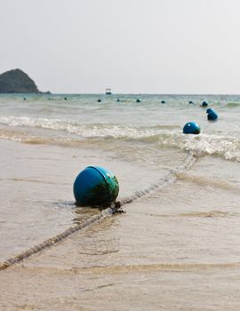 Blue buoy on the beach