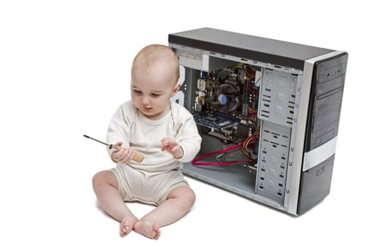young child with screwdriver in hand working on open computer in white background.