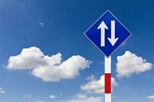 Curved Road Traffic Sign over blue sky