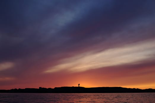 The silhouette of an island along the western coast of Norway close to Stavanger in a very colorful evening 