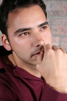 Male model against a rough brick wall background 