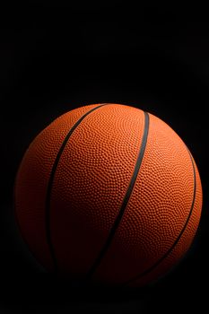 Orange basketball on black background