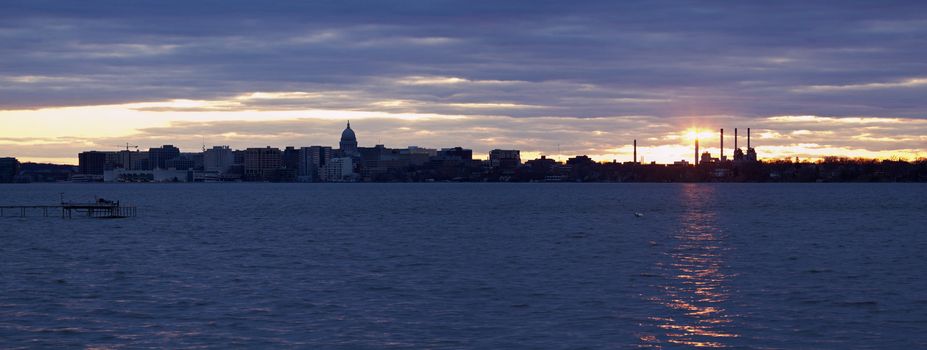 Sunset panorama of Madison. Downtown and State Capitol Building seen accross Lake Monona.