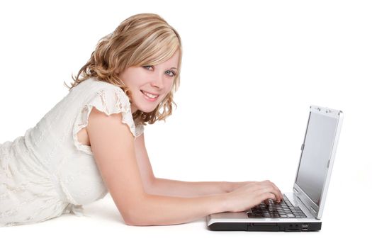 Smiling blond woman using laptop