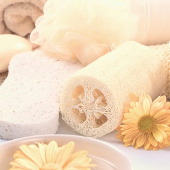 Spa still life with sponge, flower and towel with a toning effect (Selective Focus, Focus on the round natural sponge and the flower beside)