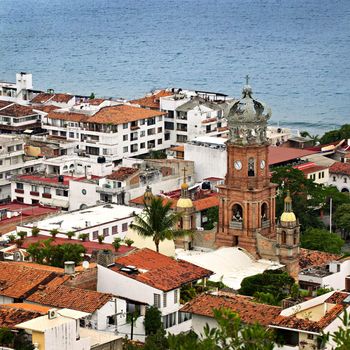 Cityscape view from above with church and Pacific ocean in Puerto Vallarta, Mexico