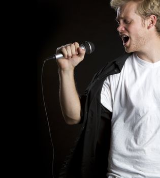 Young man singing microphone karaoke