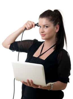 a young adult woman holding a notebook and putting a power cable to hear head