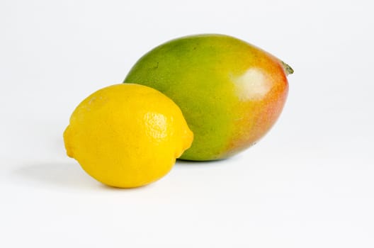 Colorful mango and yellow lemon isolated on a white background.