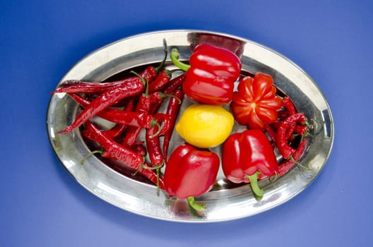 Vegetables and fruits in a big metal plate.