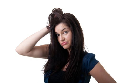 a clueless looking young woman with her hand in her hair