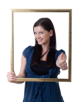 a young woman looking through a picture frame showing thumb up