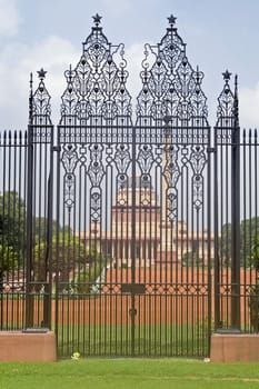 Wrought iron gates to Rashtrapati Bhavan (former Viceroy's House when Indian was under British rule). Large imperial building. New Delhi, India