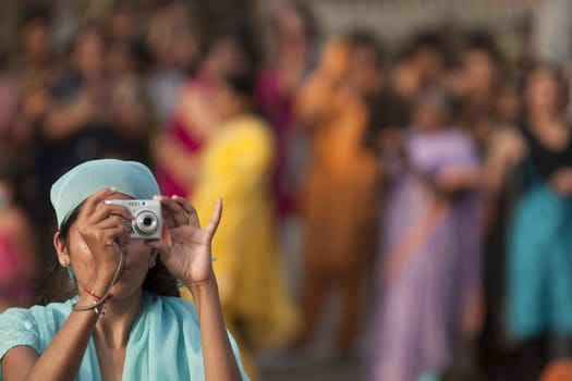 Indian lady taking photographs of the ceremony closing the border between India and Pakistan at Wagah, Punjab, India