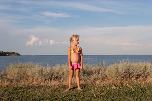 child on the beach in the evening