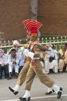 Indian soldiers in dress uniform marching as part of the ceremony closing the border between India and Pakistan at Wagah in Punjab, India