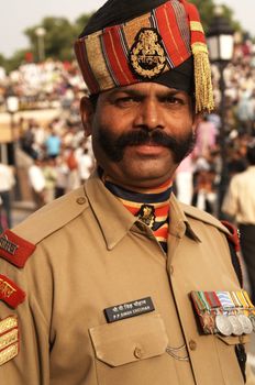 Imposing Indian soldier with bushy mustache in dress uniform. Wagah Boarder Post between India and Pakistan