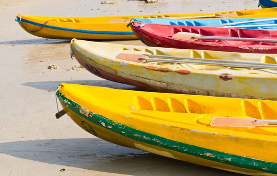 Old Colourful kayaks on the beach