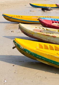 Old Colourful kayaks on the beach