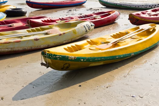 Old Colourful kayaks on the beach